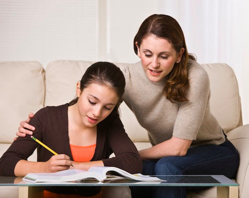 Woman Helping Daughter with Homework